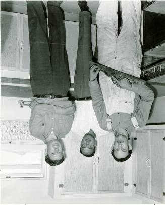 Three Men in a Kitchen Under Construction