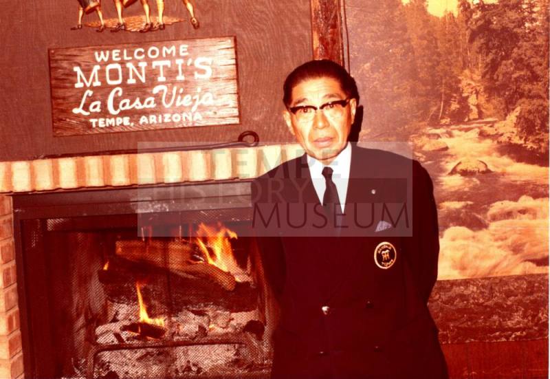 Shojiro Ozu stands in front of Monti's Restaurant Sign