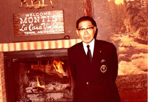 Shojiro Ozu stands in front of Monti's Restaurant Sign