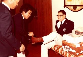 Shojiro Ozu tries on Cowboy Boots at Monti's