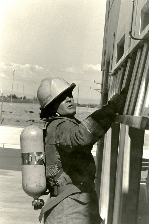 Tempe Fire Department Fireman Holding onto Horizontal Ladder