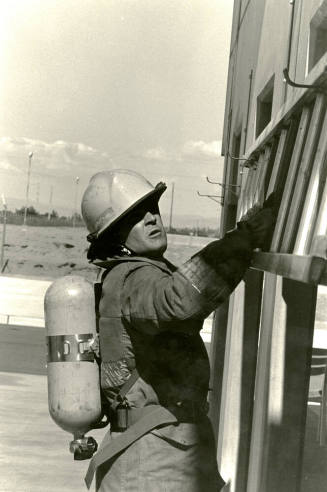 Tempe Fire Department Fireman Holding onto Horizontal Ladder