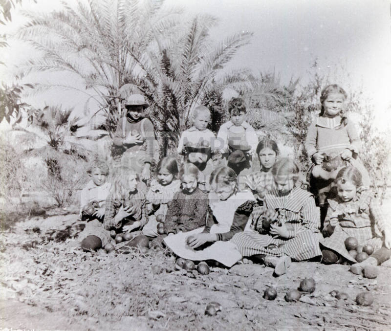 Twelve Children Holding Oranges