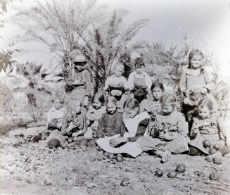 Twelve Children Holding Oranges