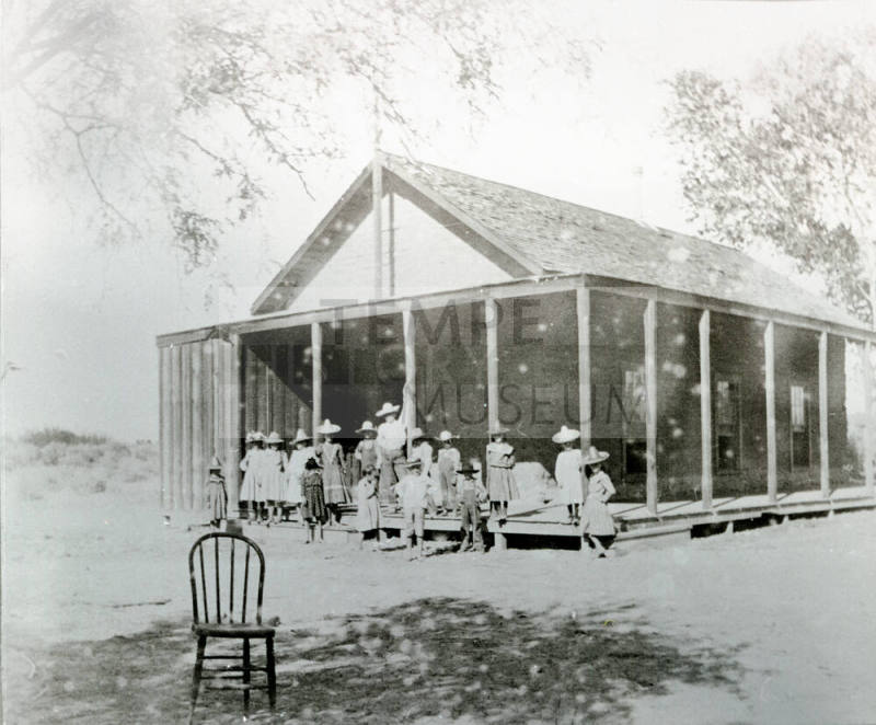 Group of Children Standing Near Porch of Double Butte Schoolhouse