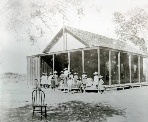 Group of Children Standing Near Porch of Double Butte Schoolhouse