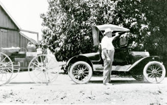 Man standing near car on Petersen Property