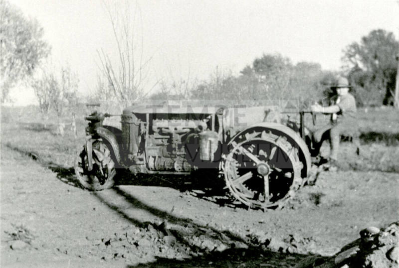 Man riding tractor on Petersen property