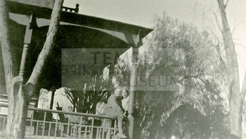 Women standing on the porch of the Petersen house