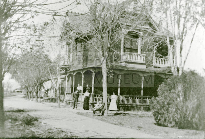 Six people standing in front of the Petersen house