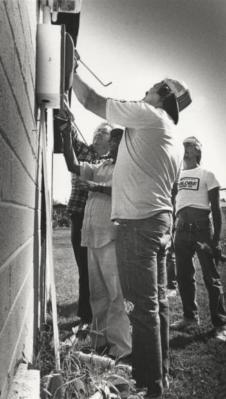 Ceta Workers Re-Caulk a Window