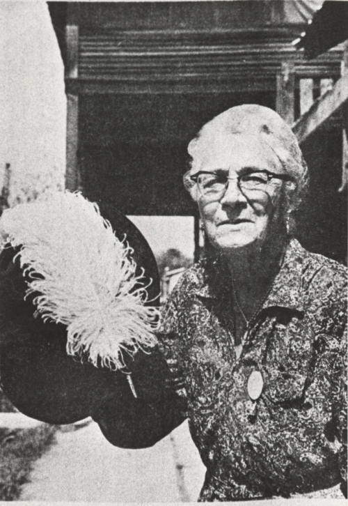 Stella Hackett Standing Holding Her Hat