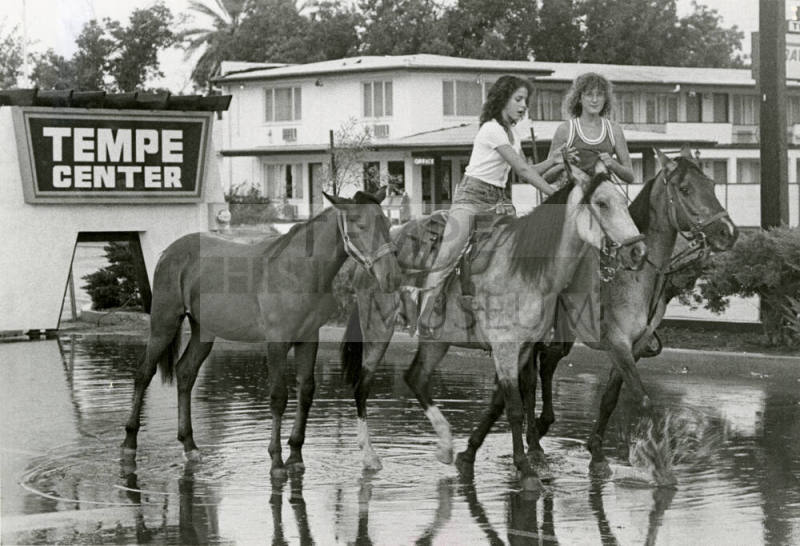 Girls Ride Horses Through Flood Waters