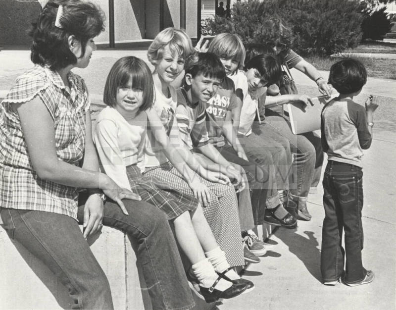 Students Wait Outside Bustoz School