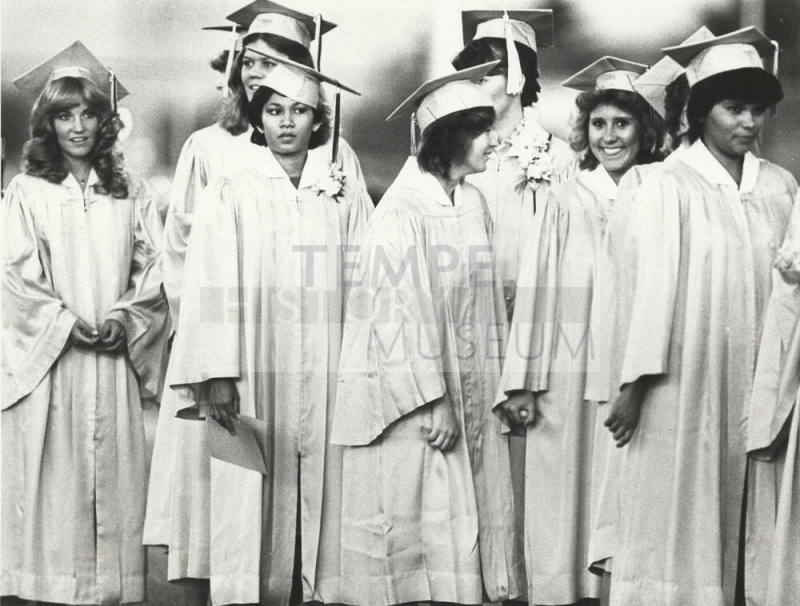 Young Women in Graduation Caps and Gowns