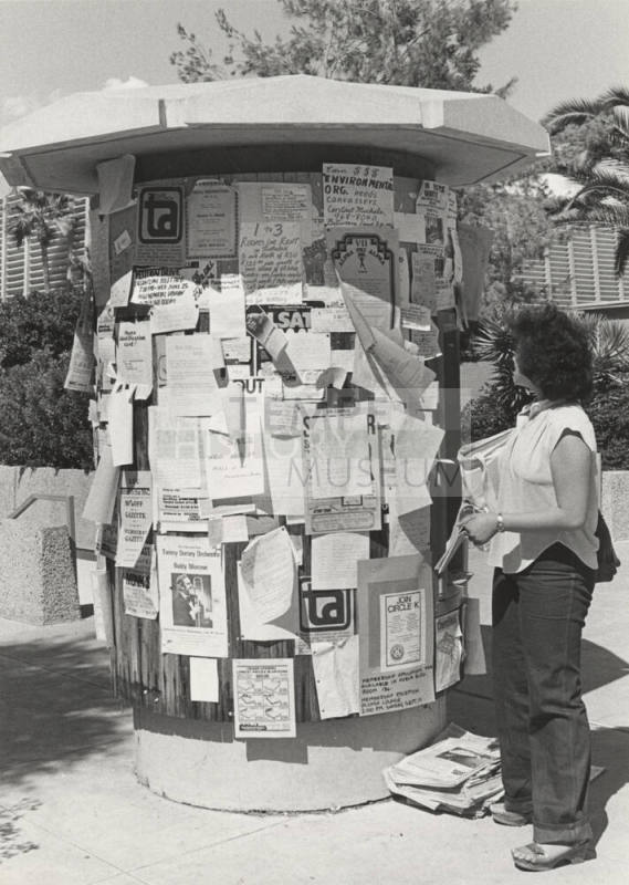 Jeannie Ong Looks at Arizona State University Bulletin Stand