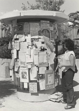 Jeannie Ong Looks at Arizona State University Bulletin Stand