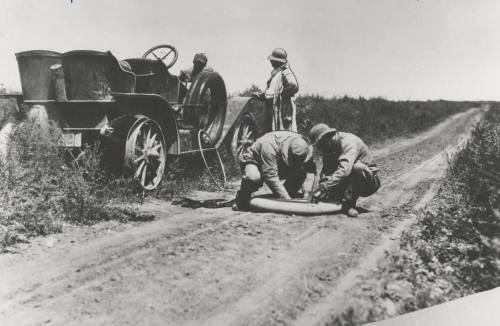 Two Men Repair a Circa 1920 Car Tire