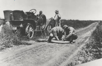Two Men Repair a Circa 1920 Car Tire