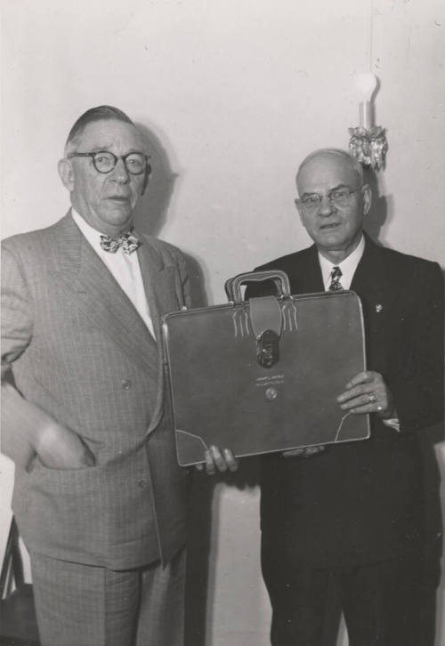 Photo- two men holding a briefcase