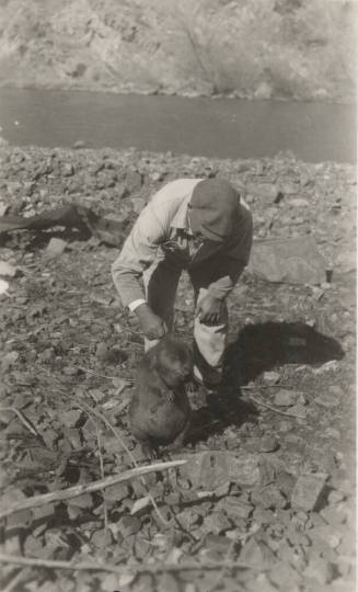 Photo- Man holding a beaver at the Roosevelt Dam