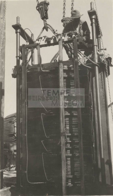 Photo- worker on a 110 KV transformer at the Mesa switching station