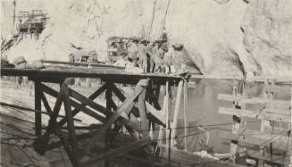 Photo- workers pulling rope at Mormon Flat dam