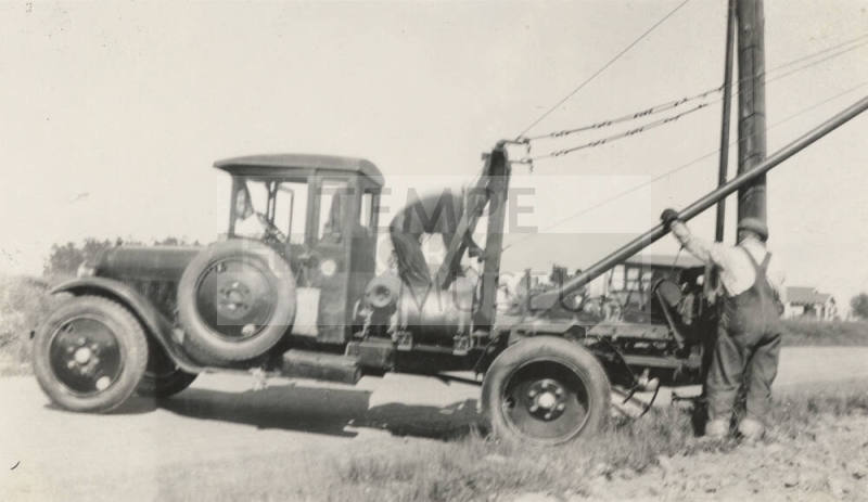 Photo- line truck and men working on power lines