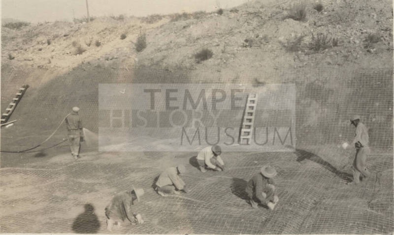 Photo- men working on canal lining