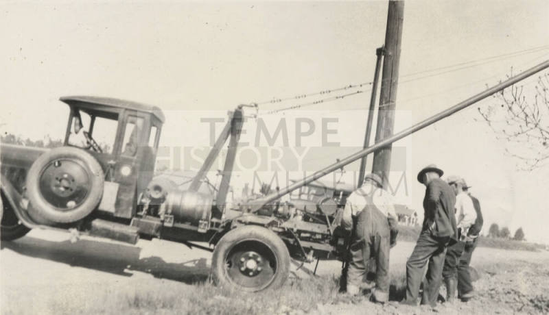 Photo- men installing power line with Dodge-Graham truck