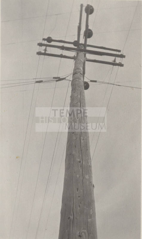 Photo- power pole with crossbars and power lines