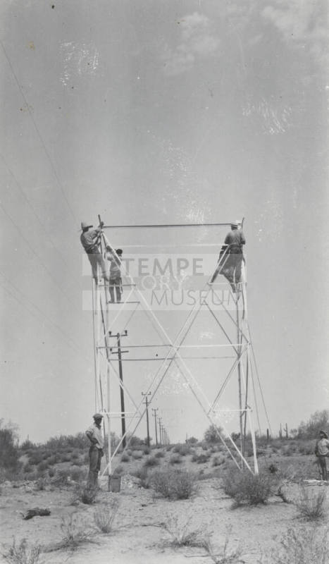 Photo- construction crew erecting a line tower
