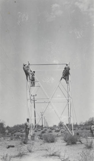 Photo- construction crew erecting a line tower