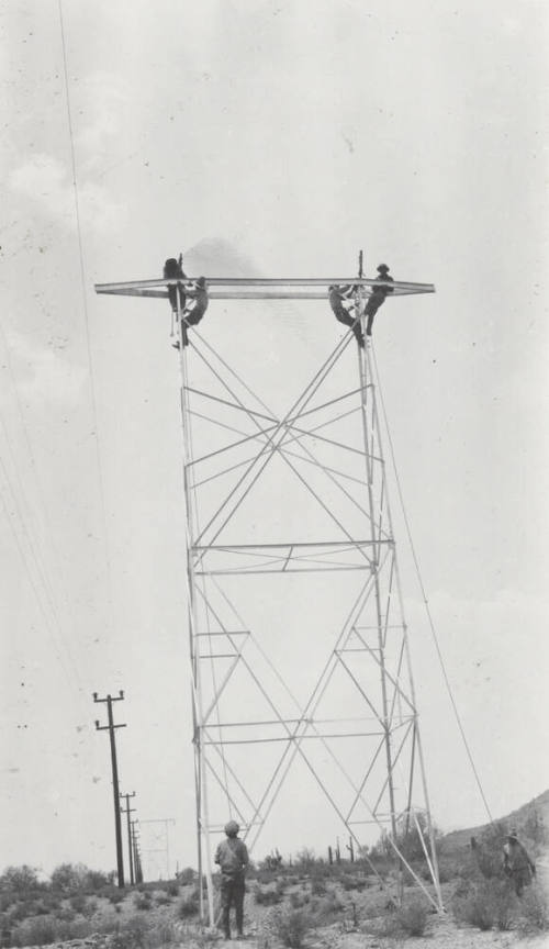 Photo- construction crew erecting a line tower