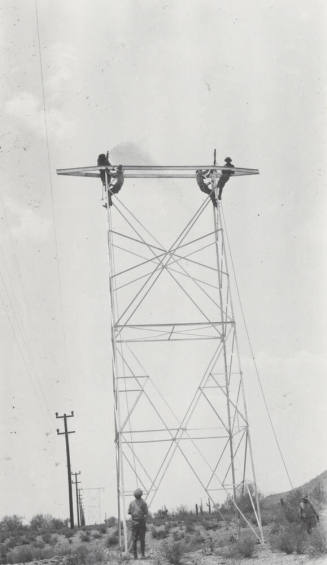 Photo- construction crew erecting a line tower