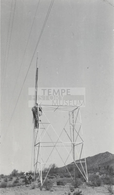 Photo- construction crew erecting a line tower
