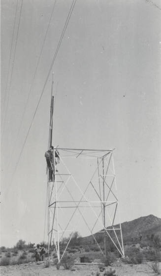 Photo- construction crew erecting a line tower