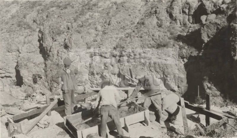 Workers pouring cement footers for Horse-Mesa Line