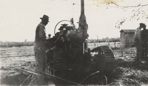 Man operating a pole digging nachine