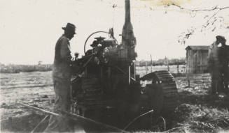 Man operating a pole digging nachine