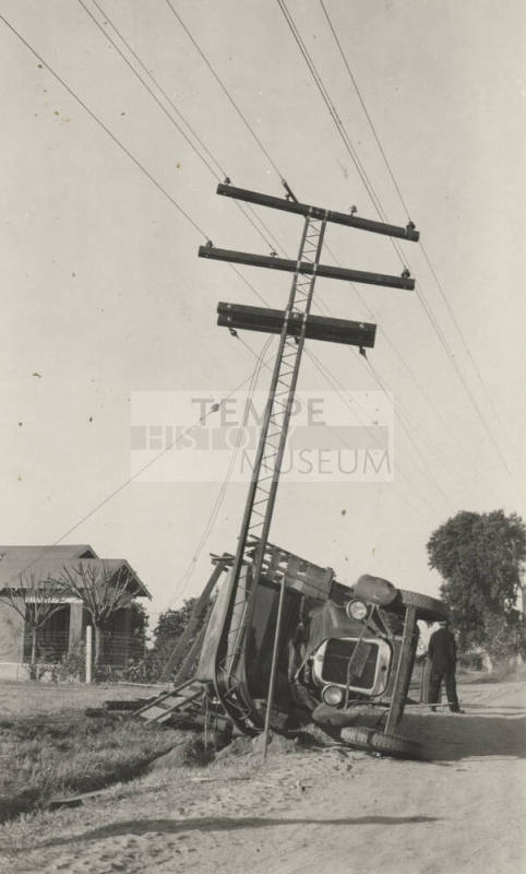 An overturned truck after colliding with the power line pole