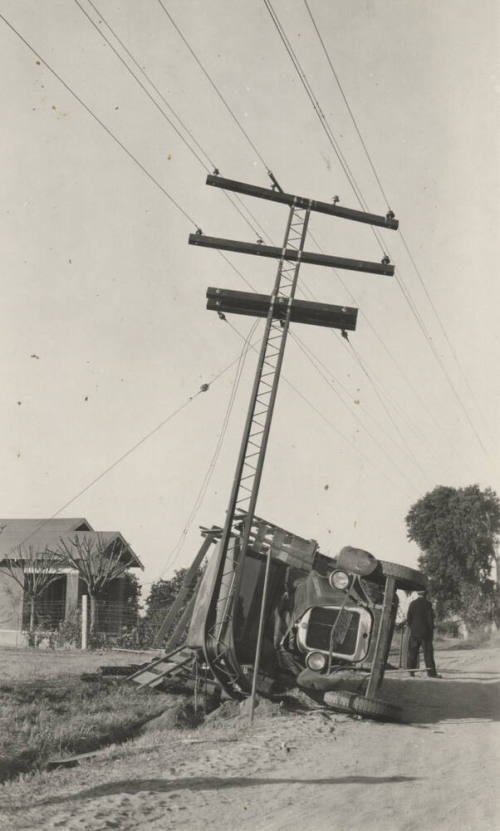 An overturned truck after colliding with the power line pole
