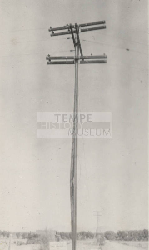 Photo-View of power line poles with bent pole