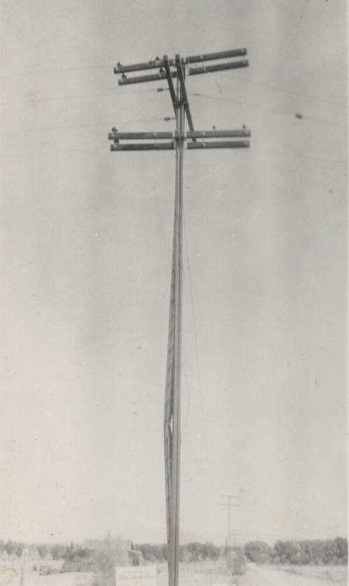 Photo-View of power line poles with bent pole