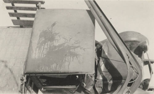 Photo-View of overturned truck and bent power poles