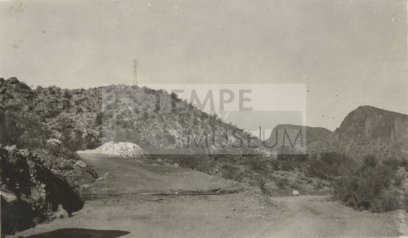 Photo-View of the high desert with roadway and power line tower