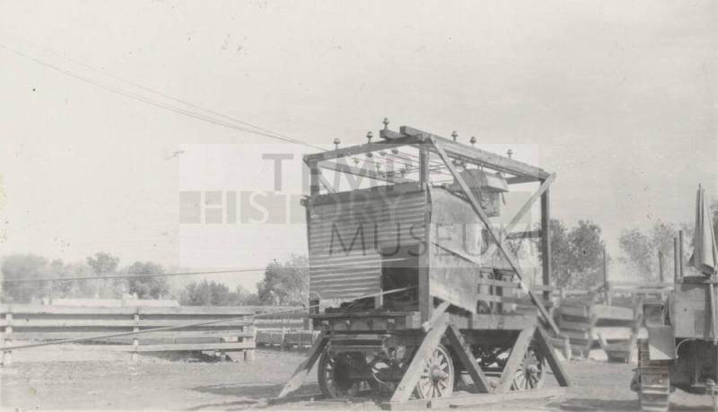 Photo- View of a early mobile electricial generator and tractor