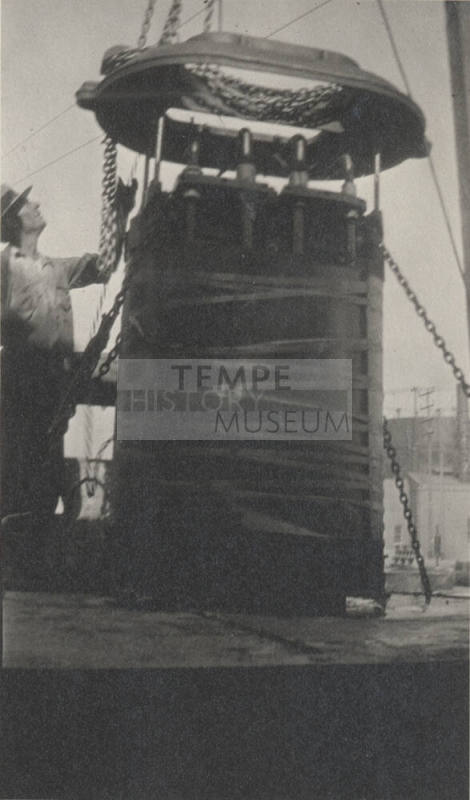 Photo-Man standing next to 100 KW 40,000-60,000 volt transformer from Macrineth