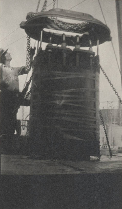 Photo-Man standing next to 100 KW 40,000-60,000 volt transformer from Macrineth