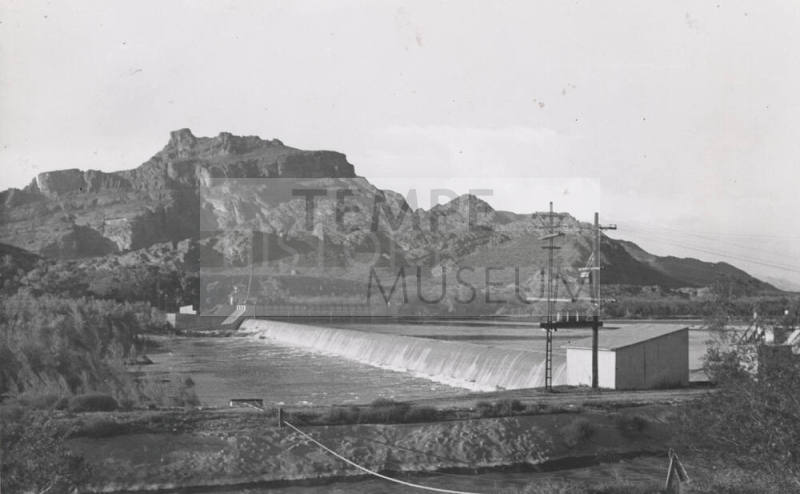 Photo- View of Granite Reef Diversion Dam, power lines and canal in foreground
